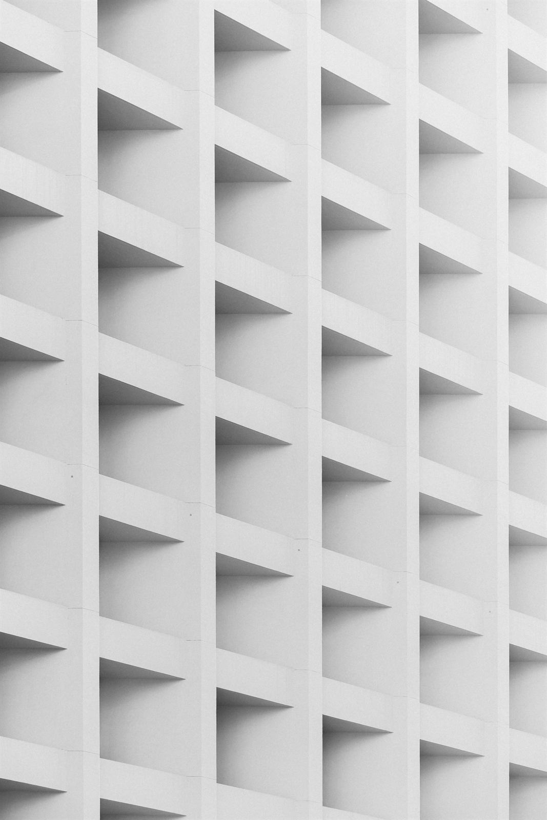 White building facade with a repeating grid of windows