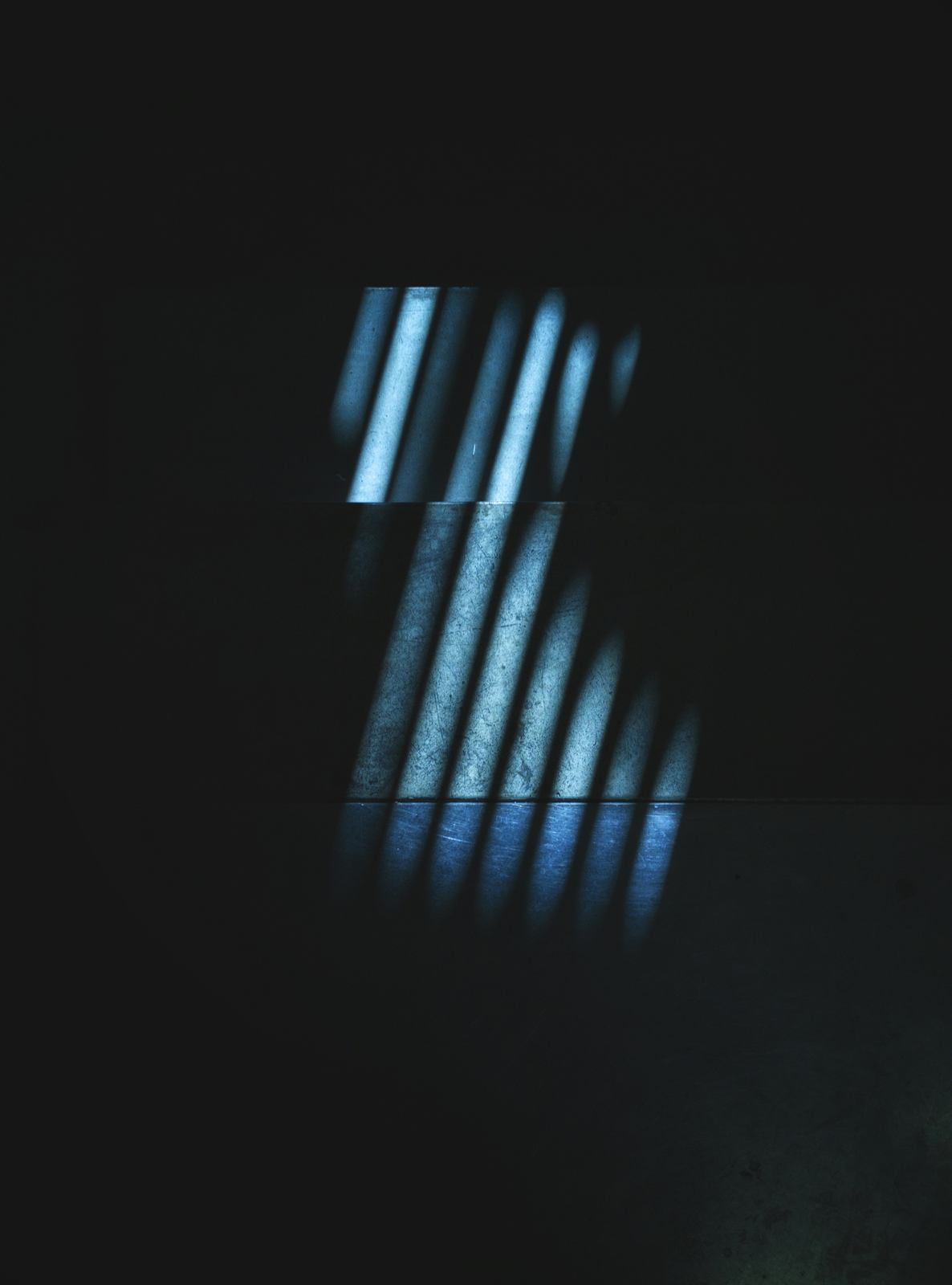 Blue light stripes falling across dark steps