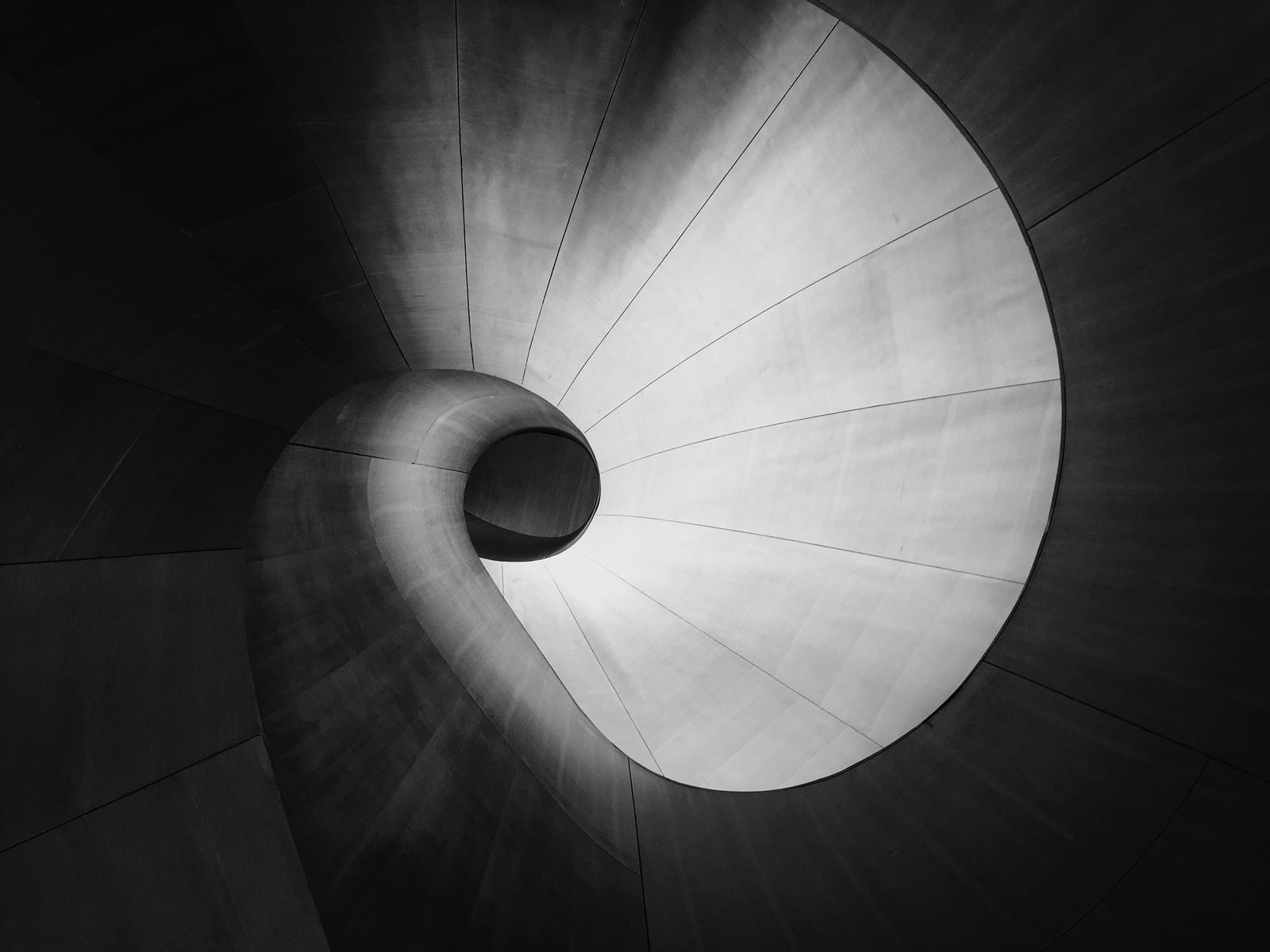 Black and white spiral staircase seen from below